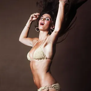 Actress Caroline Munro wearing gold bikini 1983 Played a James Bond girl in