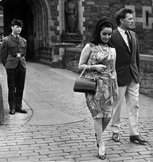 Actress Elizabeth Taylor with her husband Richard Burton walk away disappointed after not