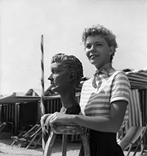 Actress Francis Farmer seen here having bust created on the beach near Venice
