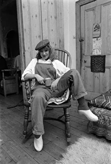 Dungarees Prints: Actress Helen Mirren seated in her country Windsor chair wearing her favorite cap