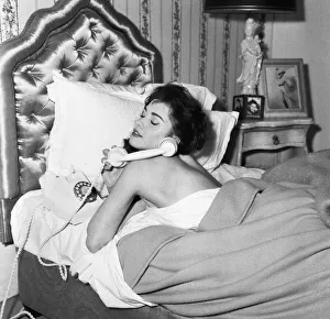 Screen Prints: Actress Jackie Lane lying in bed naked talking on the telephone March 1959