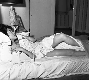 Screen Prints: Actress Jackie Lane lying naked on the bed talking on the phone March 1959