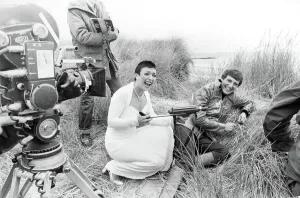 Actress Jacqueline Pearce as Servalan and Paul Darrow as Avon share a joke during filming