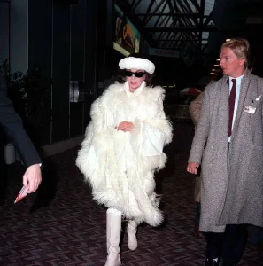 Actress Joan Collins arriving at Lodon Airport February 1987