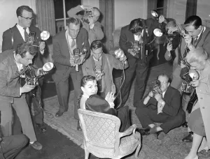 00161 Prints: Actress Judy Garland at a press conference surronded by photographers taking