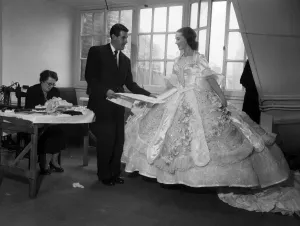 Young Prints: Actress Julie Andrews trying on a dress for her role in the pantomime Cinderella