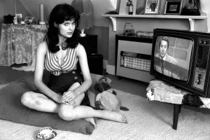 Actress Madeline Smith watching television at her flat in Kew. 6th September 1974