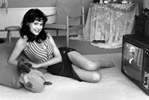 Actress Madeline Smith watching television at her flat in Kew. 6th September 1974