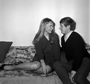 Actress Mia Farrow with singer John Leyton April 1964 sitting on sofa talking