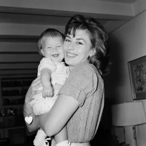 Actress Nanette Newman with her baby daughter Sarah Kate at their home in Virginia Water