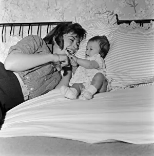Actress Nanette Newman with her baby daughter Sarah Kate at their home in Virginia Water