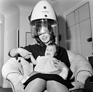 Actress Nanette Newman with her baby daughter Sarah Kate at their home in Virginia Water
