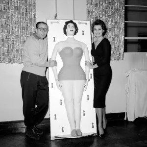 Actress Sophie Loren seen here standing beside a life size cake of her self Circa