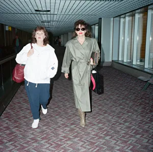 01147 Prints: Actresses Joan Collins and Pauline Collins at Heathrow Airport. 8th April 1990