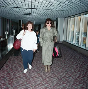 01147 Prints: Actresses Joan Collins and Pauline Collins at Heathrow Airport. 8th April 1990