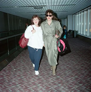 01147 Prints: Actresses Joan Collins and Pauline Collins at Heathrow Airport. 8th April 1990