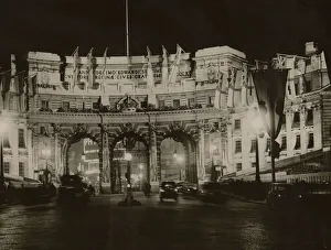 Capital Prints: Admiralty Arch flood lit and adorned with White Ensign flags in preparation for