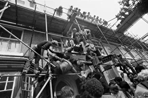 Admires climb scaffolding and occupy every other possible viewpoint to get a glimpse of