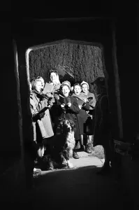 Song Prints: Adults and children carol singing at night time outside Sulgrave Manor, Northamptonshire