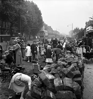 00010 Prints: Adults and children collecting road blocks in Camberwell where the tram lines are being