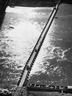 01462 Prints: Aerial view of the 1st US Army Trucks and equipment rolling across a pontoon bridge over
