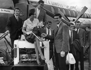 00207 Prints: Air Hostess Paddy Clinch of Dublin presents Liverpool captain Ron Yeats with a leprechaun