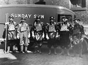Air raid precautions - Men wearing World War Two gas masks and protective clothing