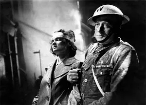 00038 Prints: Air Raid Warden Percy Dale helping a victim of the London blitz. Circa October 1940