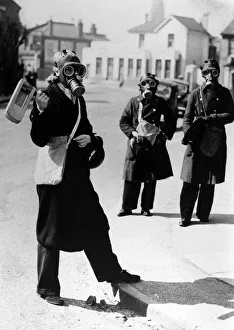 Air Raid Warden sounds her gas rattle in Kingston upon Thames during a gas alarm