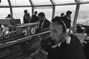 Air traffic controllers in the control tower at Heathrow Airport handling departing