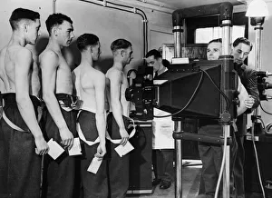 Equipment Prints: At an aircraft receiving depot, cadets are being x-rayed in modern manner