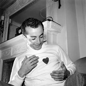 00009 Prints: Al Martino admires his new sweater. June 1953 D2956-002