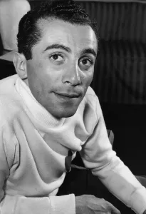 Al Martino at the Savoy Hotel, London wearing a heart sweater. June 1953