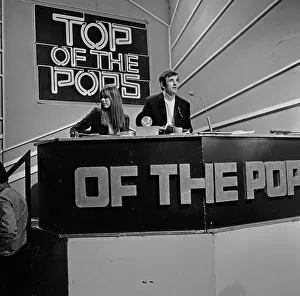Alan Freeman, (black jacket, white roll neck sweater, sitting behind the microphone