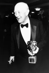 Dinner Jacket Prints: Alec Guinness actor holding BAFTA award in March 1989