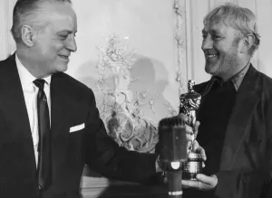 Alec Guinness receiving his Oscar for Best Actor in The Bridge on the River Kwai
