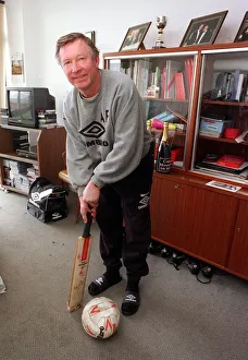 Alex Ferguson manager of Manchester United Football Club with a cricket bat