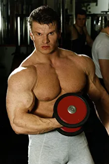 Alex Georghev one off the TV Gladiators Hawk seen in the fitness gym lifting a bar bell