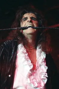 Alice Cooper pop singer with whip in his mouth on stage at Barrowlands Glasgow