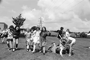 Field Prints: All fall down! Contestants in the three-legged race at Scissett C of E First School