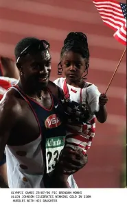 Allen Johnson celebrates with his daughter after winning the gold medal in the 110 metres