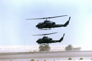 Helicopters Prints: Two allied Cobra helicopter gunships seen here leaving a Saudi Airforce desert airfirld