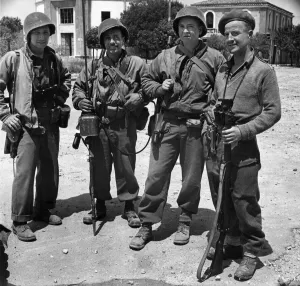 01153 Prints: Allied soldiers of four different nations searching through the town of Littoria in Italy