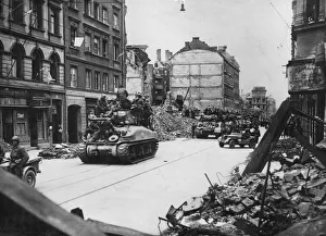 Jeep Prints: Allied tanks laden with infantry move into a heavily bombed Munich on April 29, 1945