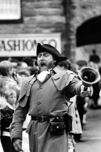 Mouth Prints: Alnwick Town Crier John Stevenson heads the procession through the town 26 June 1983