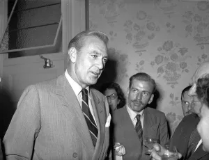 Suits And Jackets Prints: American actor Gary Cooper talking to people upon his arrival in England