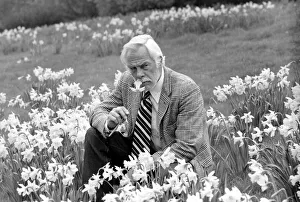 American actor Lee Marvin smelling the spring flowers during a visit to England