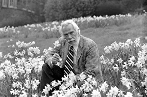 American actor Lee Marvin smelling the spring flowers during a visit to England