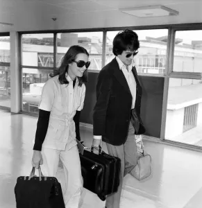 American actor Warren Beatty at Heathrow Airport with Michelle Phillips. May 1975