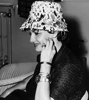 American actress Jane Russell wearing flowerpot hat holding her hand to her face